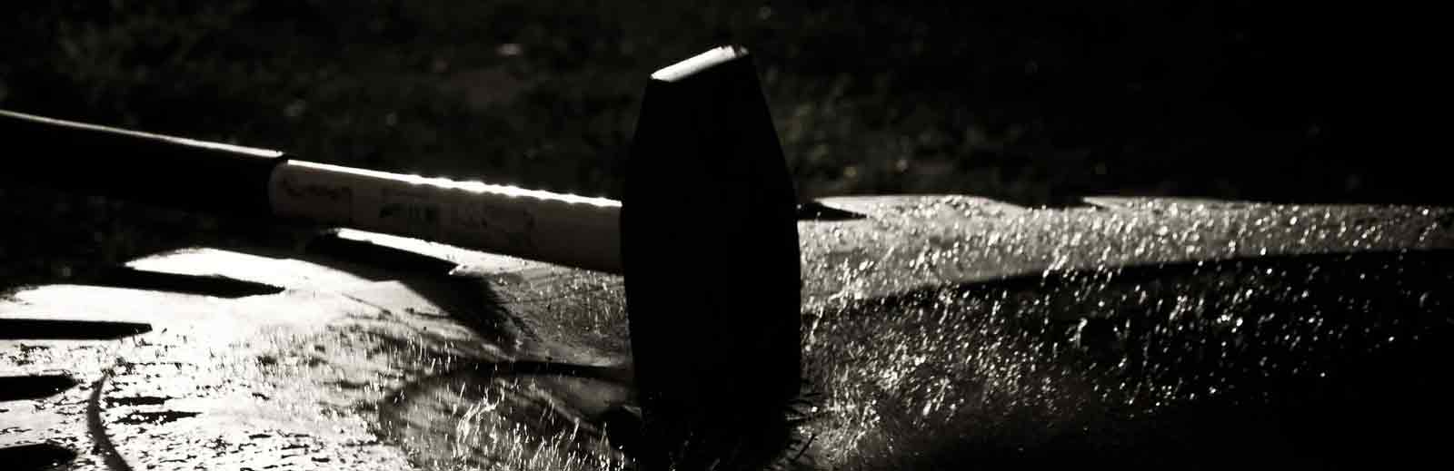 hammer being hit on to a big tyre